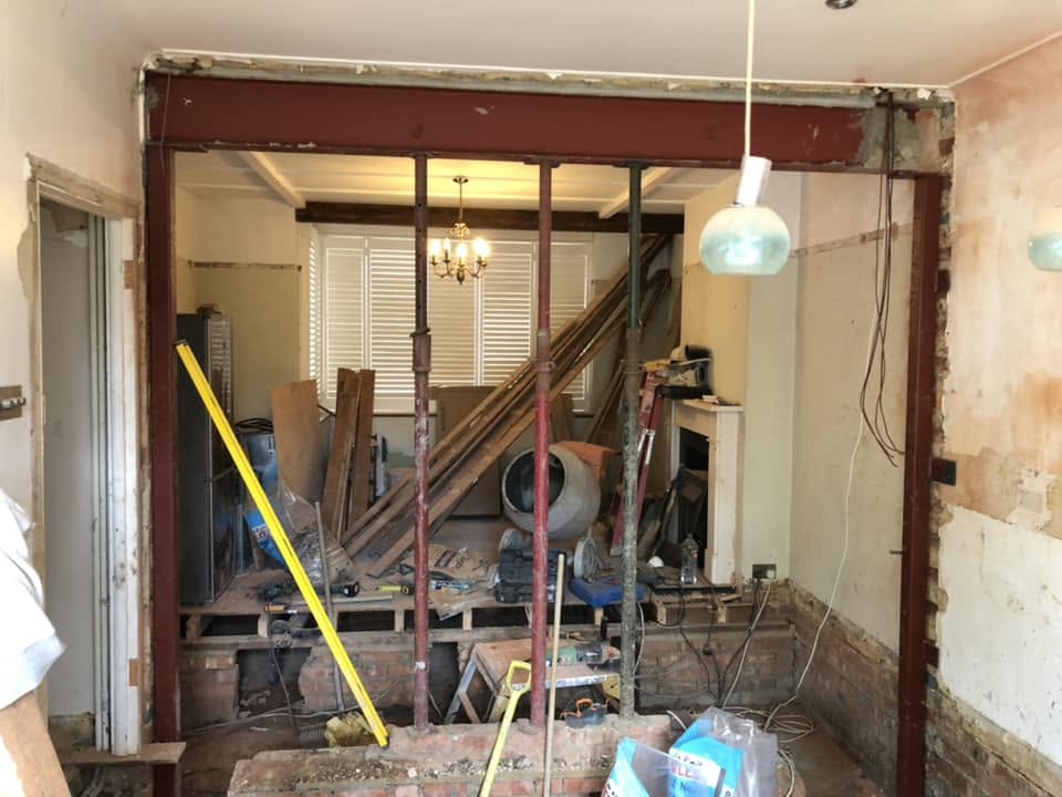 Structural steel beam and acrow props during a knock-through strip out