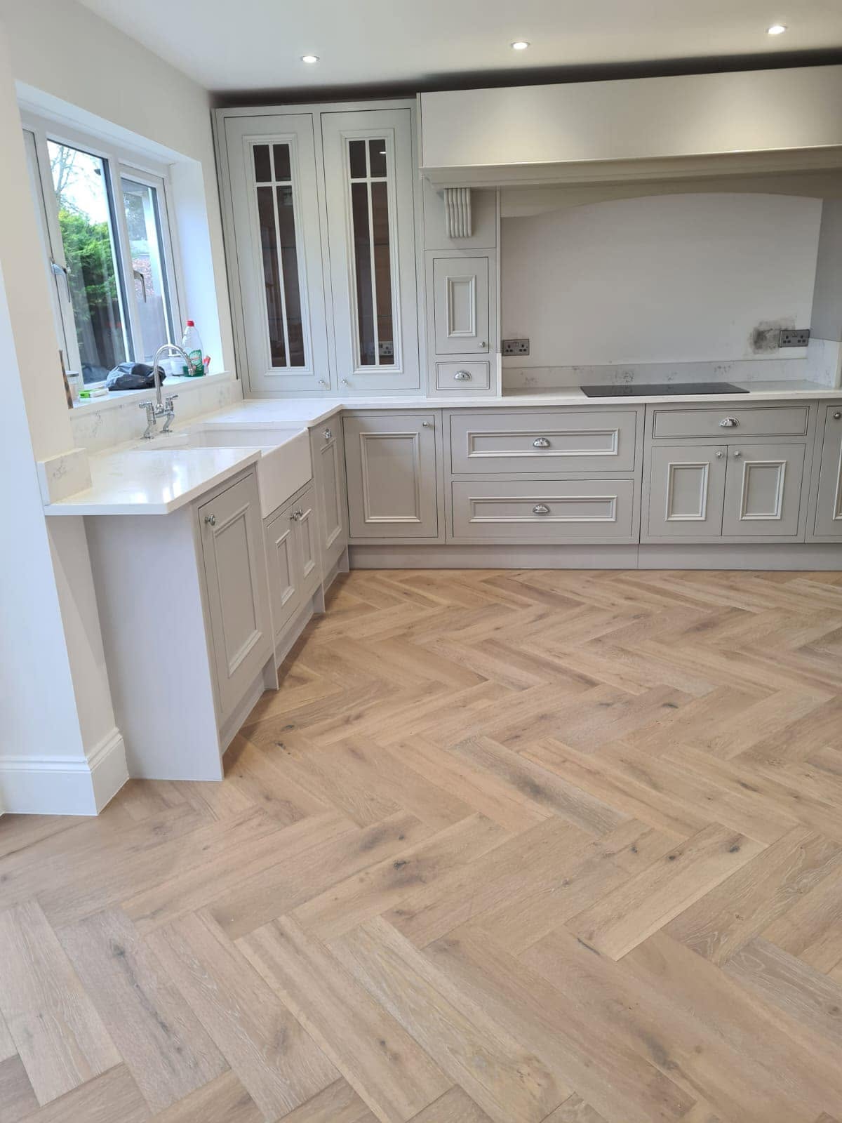 Bespoke shaker kitchen with quartz worktops and herringbone oak flooring