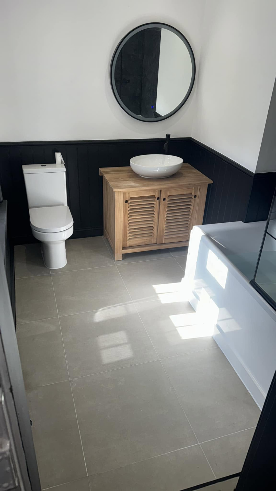 Fitted bathroom vanity with stone top and recessed lighting